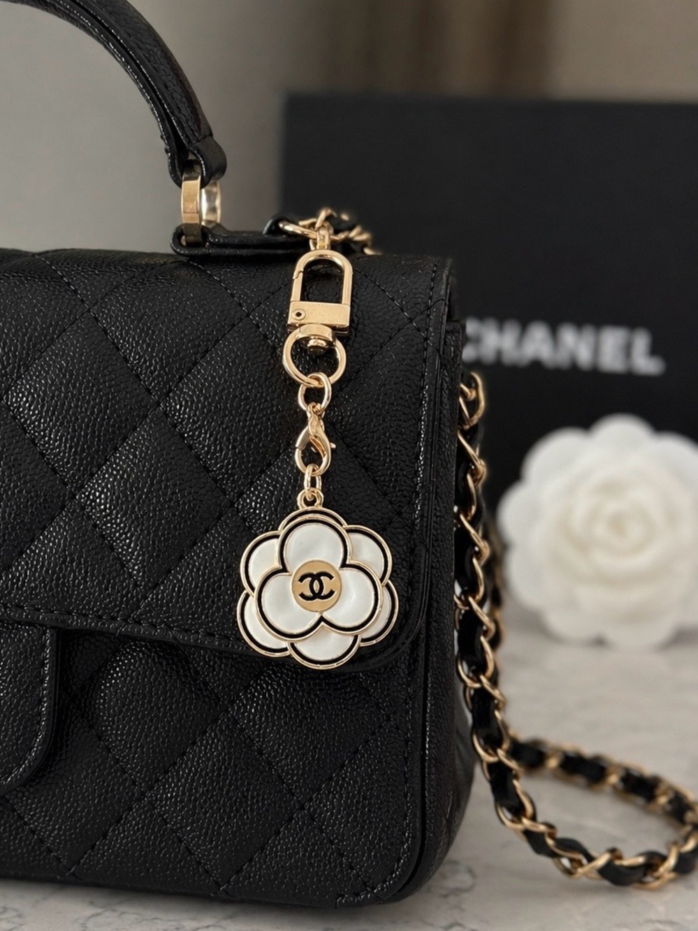 CHANEL GUC Camellia Bag Charm/zip
pull stamped. 3D Cream enamel Gold
Black trim